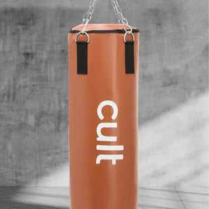 cult Punching Bag Tan 4ft Heavy Duty Punching Bag for Boxing, Kickboxing, MMA Training Reinforced Stitching Durable PU Leather Hanging Chain Included Unfilled Easy to Install For Home & Gym Use